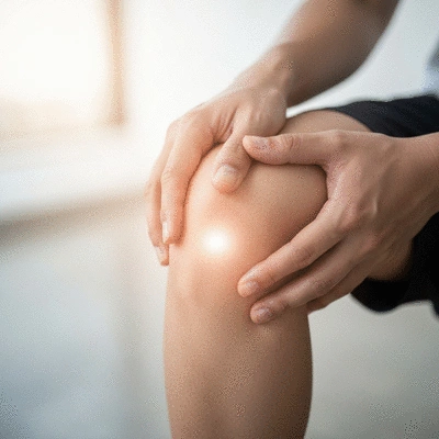 A serene close-up of a person's hand gently touching a knee, with subtle glowing light effects indicating pain relief and healing, no text, no words, no typography, clean image